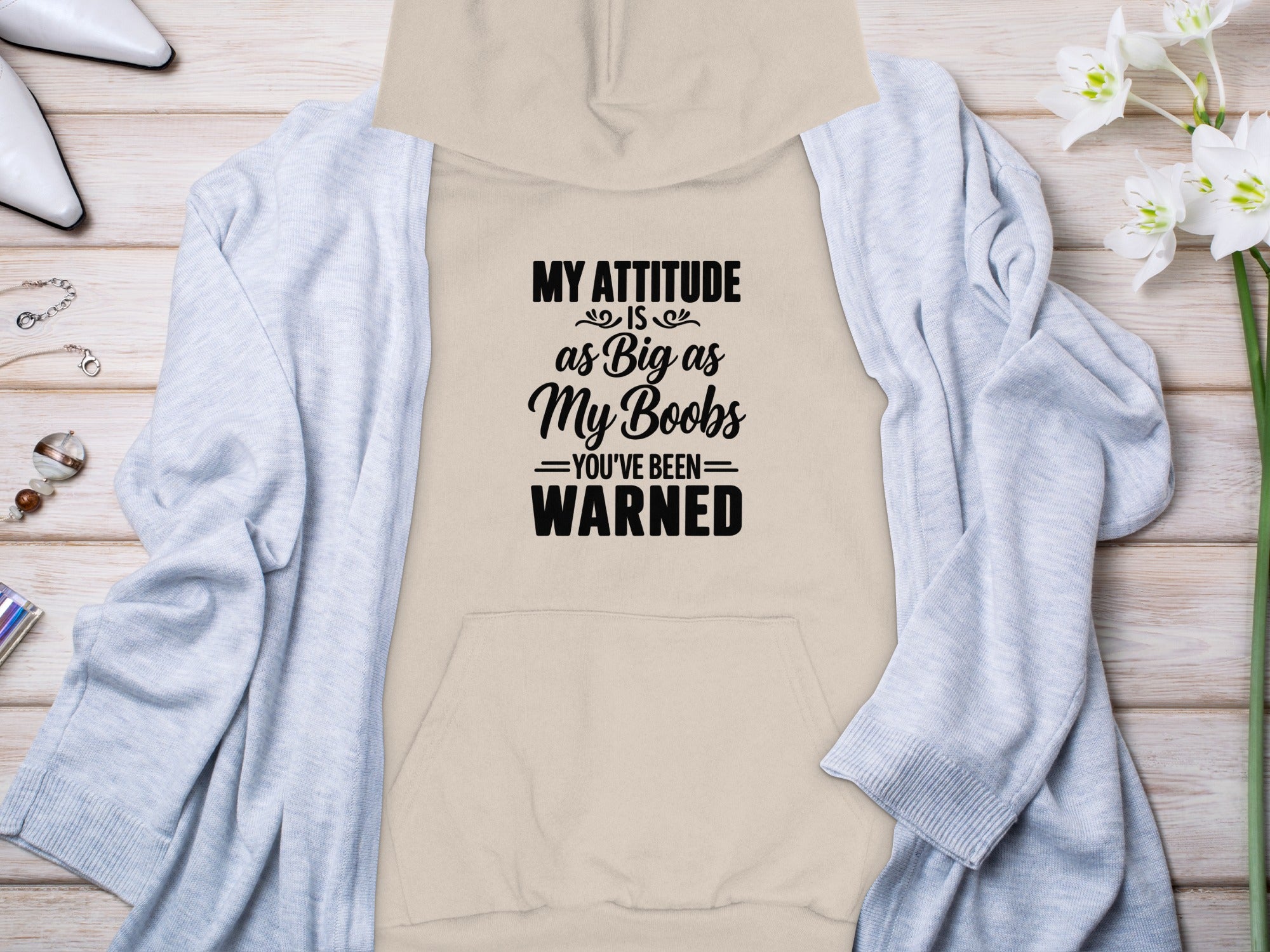 Beige hoodie with black text "My attitude is as big as my boobs, you've been warned."
