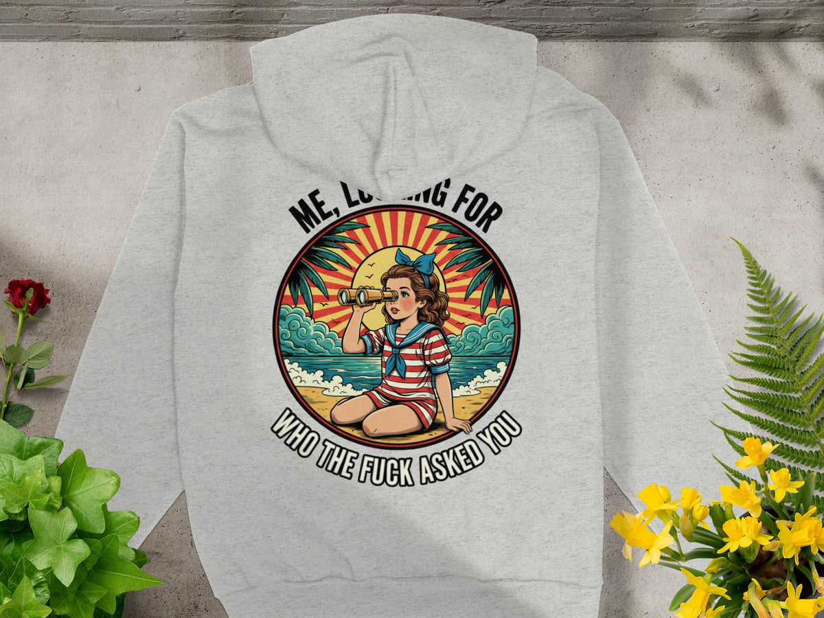 Light grey hoodie with a graphic of a girl looking through binoculars and the text "Me, Looking for who the fuck asked you".