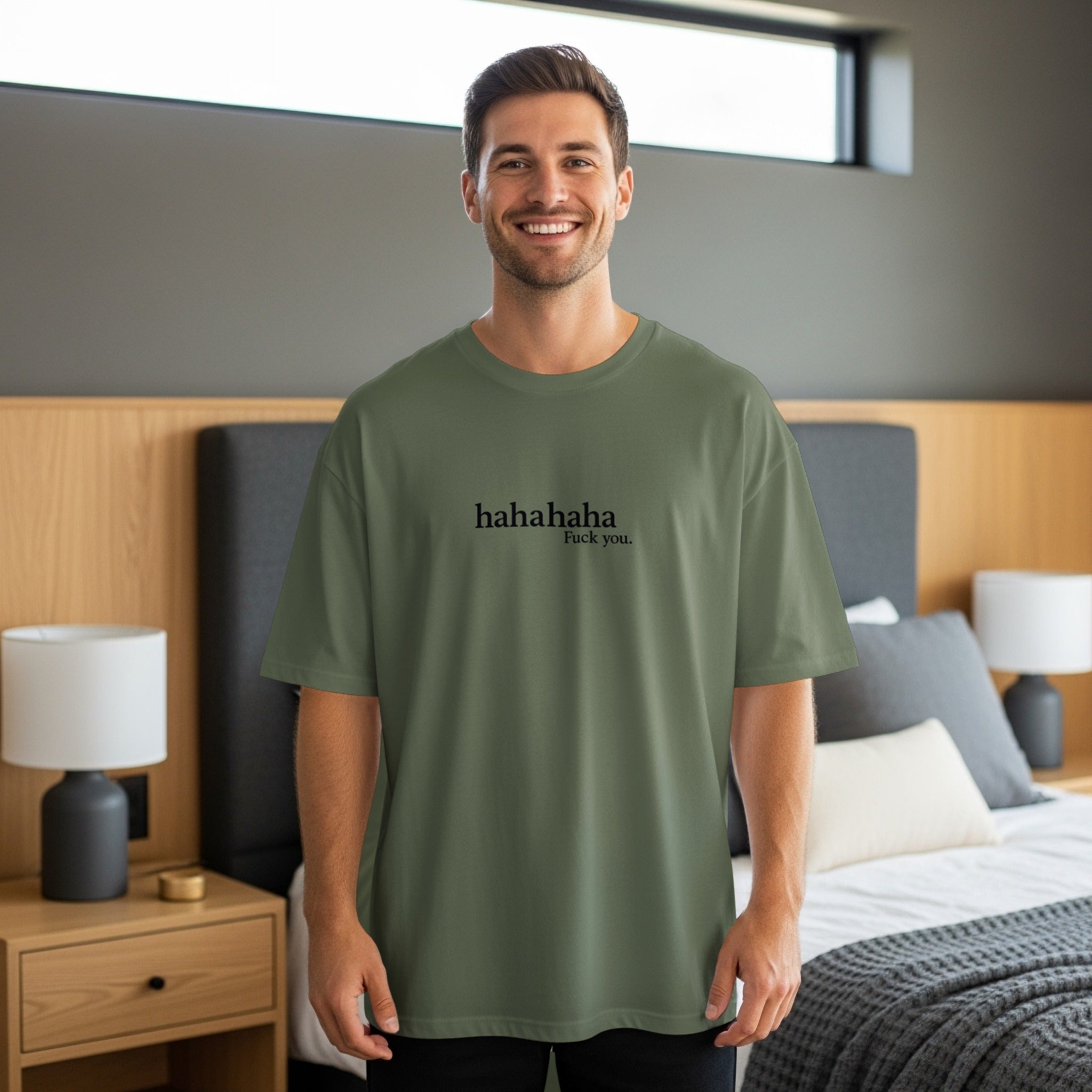 Man in olive green t-shirt with "hahahaha Fuck you." text.
