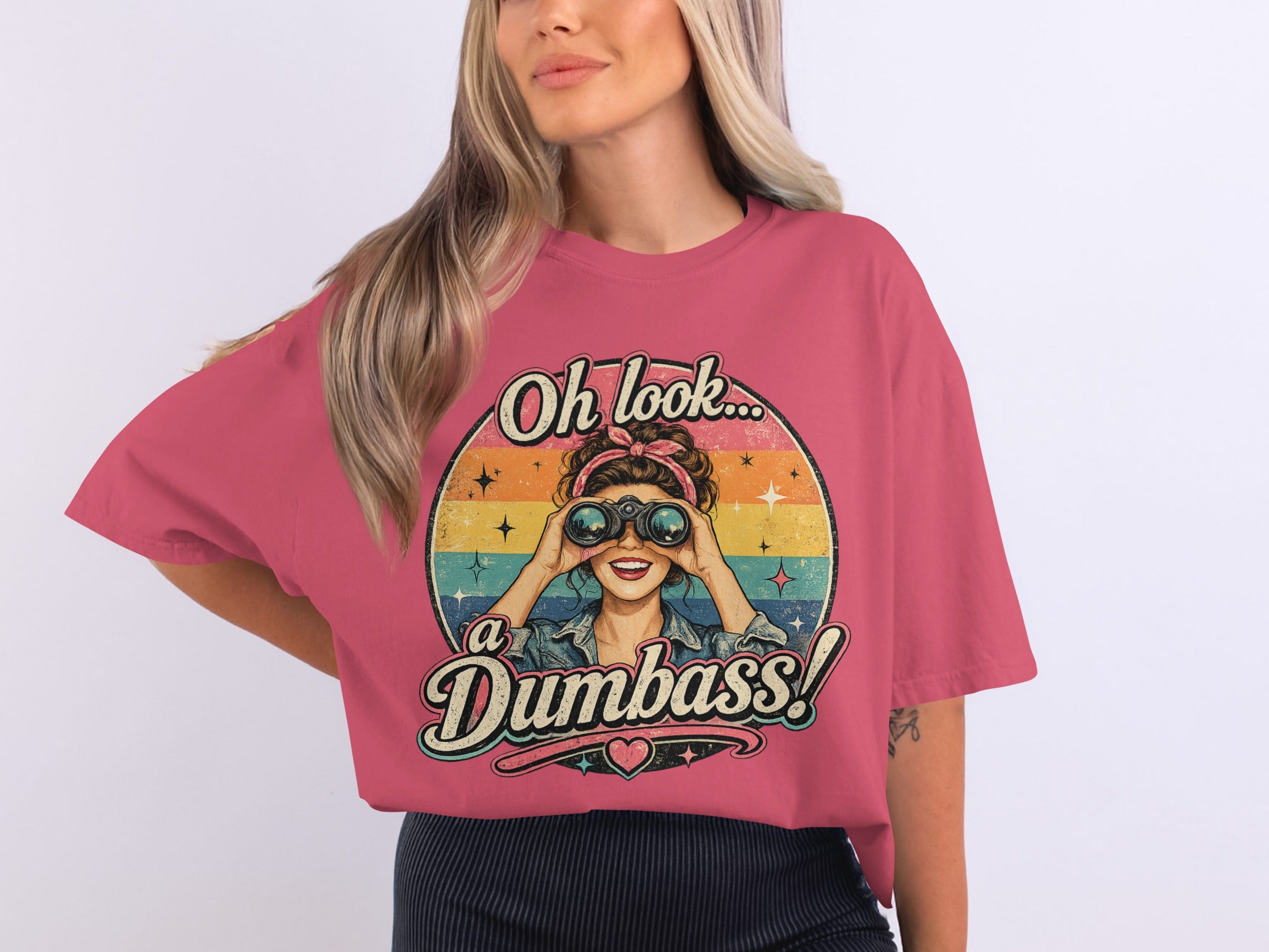 T-shirt graphic with woman looking through binoculars, text "Oh look... a Dumbass!".