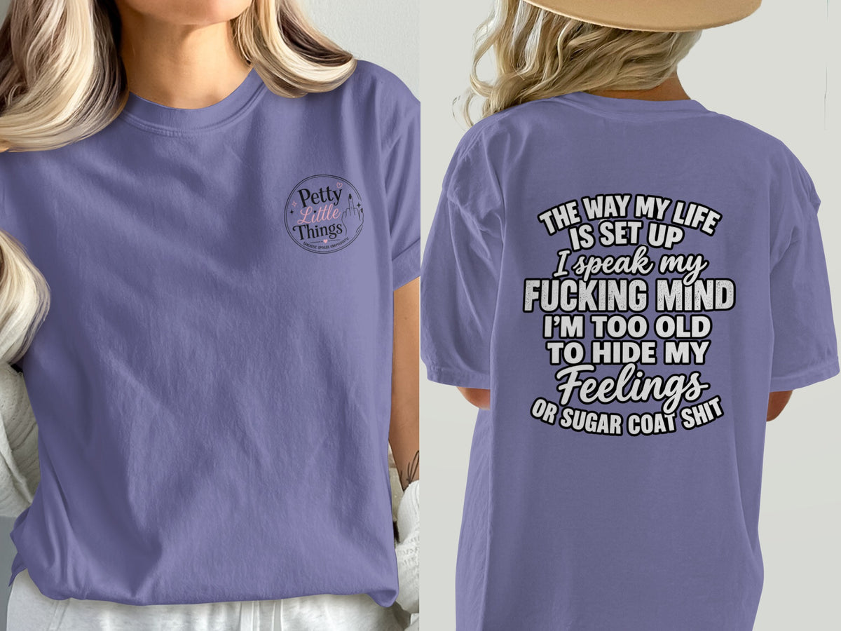 Purple t-shirt with "Petty Little Things" on front and quote on back.