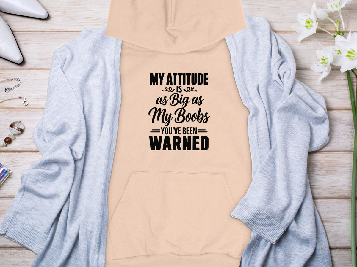 Peach hoodie with text "MY ATTITUDE IS as Big as My Boobs YOU'VE BEEN WARNED".