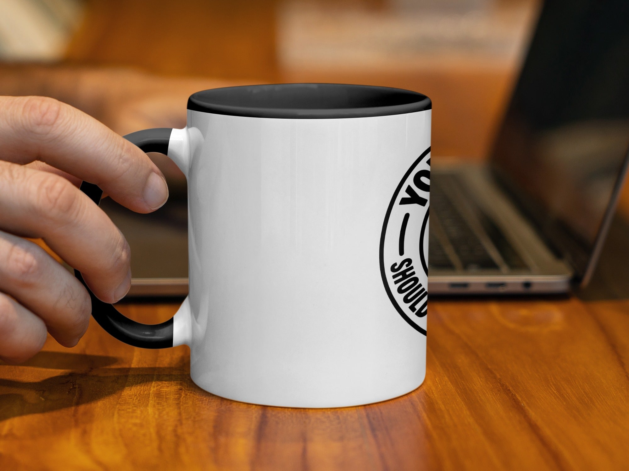 White mug with black rim, handle, and text "YOU SHOULD" inside a circle.