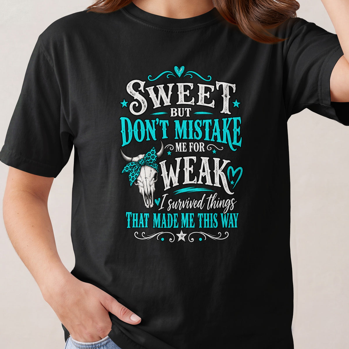 Black t-shirt with text "Sweet but don't mistake me for weak. I survived things that made me this way."