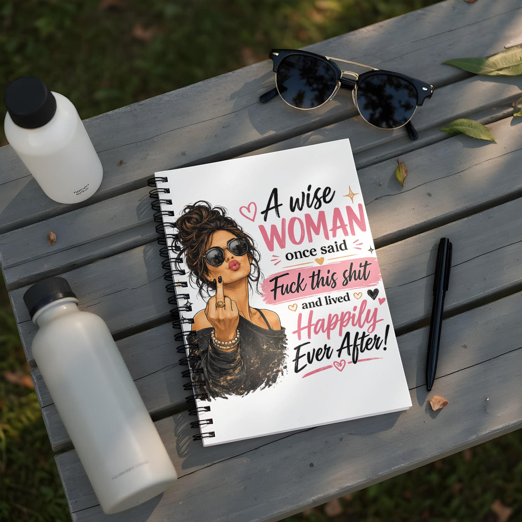 Notebook with illustration of a woman and text "A wise WOMAN once said Fuck this shit and lived Happily Ever After!"