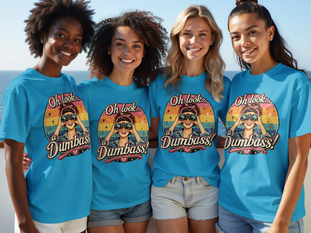 Four smiling women wear matching blue shirts with a retro graphic of a woman looking through binoculars.