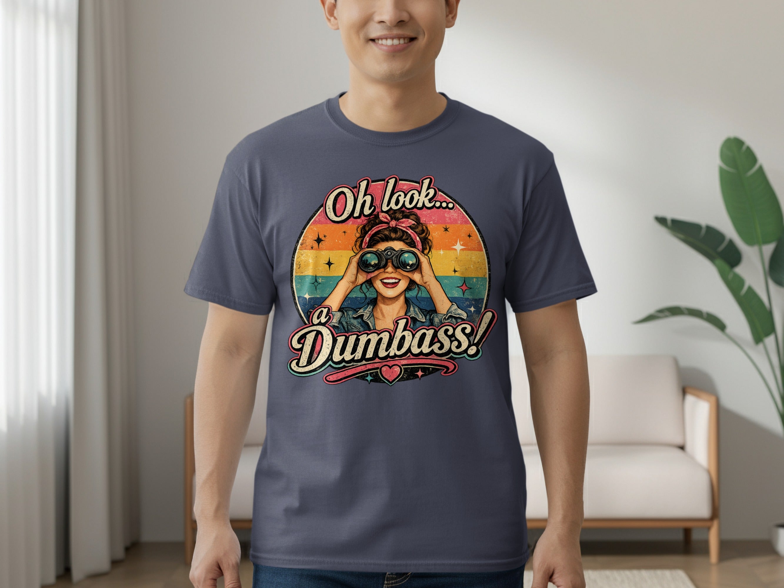 Graphic tee with woman looking through binoculars and text "Oh look... a Dumbass!"