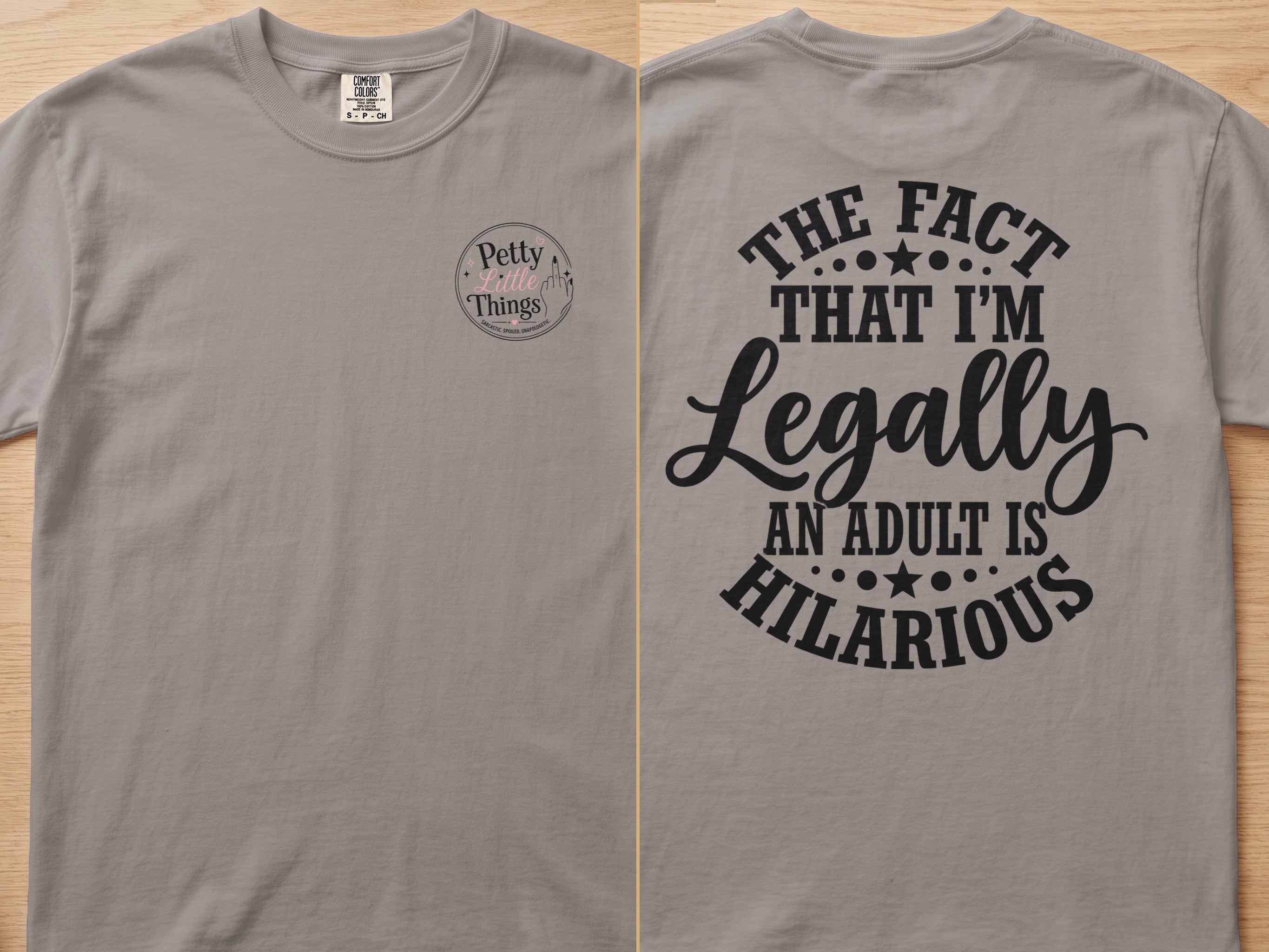 Grey t-shirt with "The fact that I'm Legally An Adult Is Hilarious" graphic.