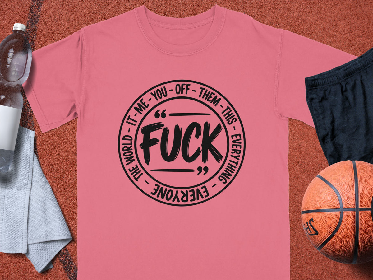 Pink t-shirt with black circular graphic reading "FUCK" with text around the circle.