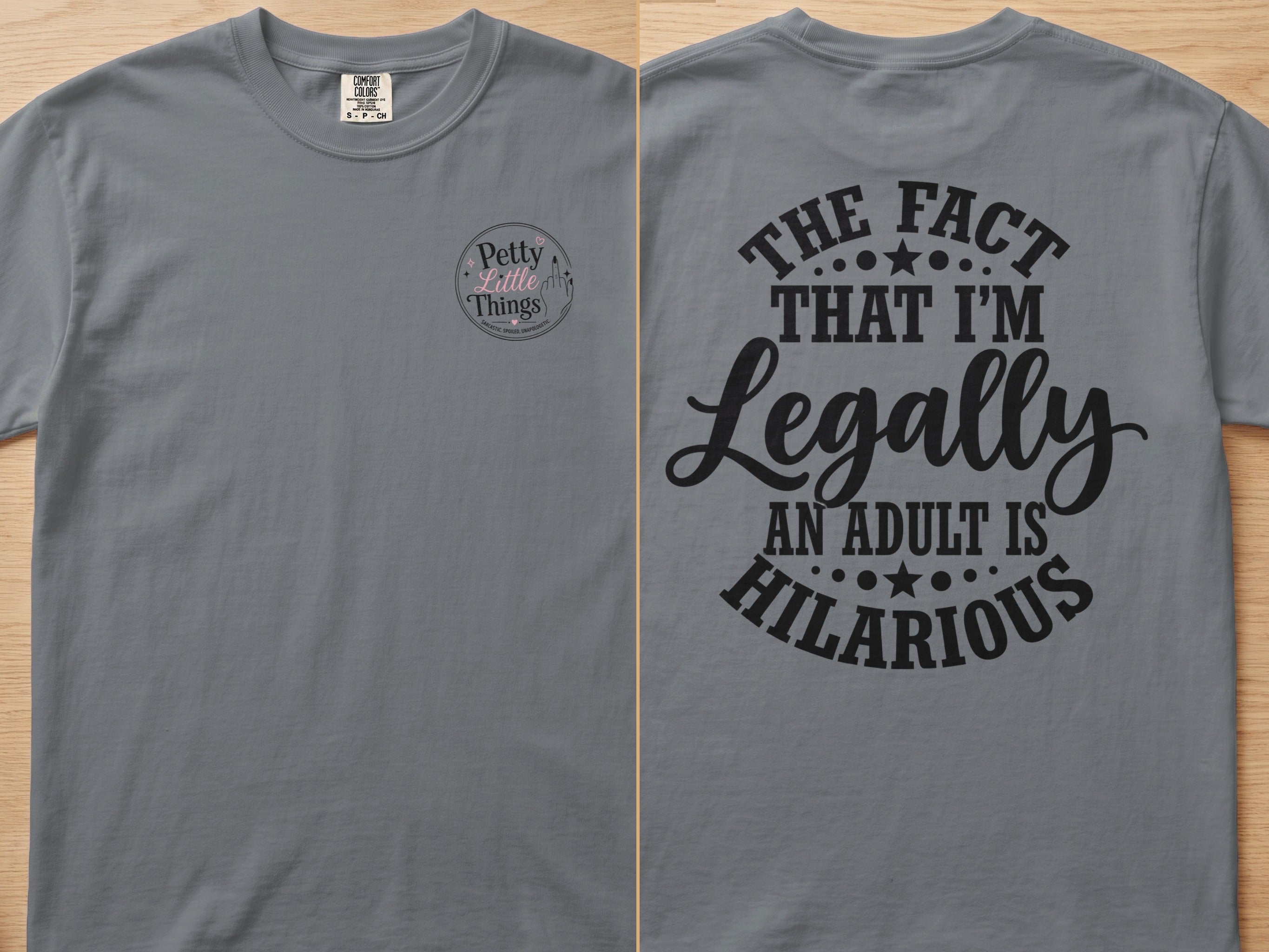 Gray t-shirt with "The fact that I'm legally an adult is hilarious" graphic.