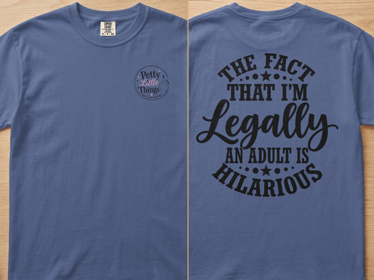Blue t-shirt with "The fact that I'm legally an adult is hilarious" graphic.