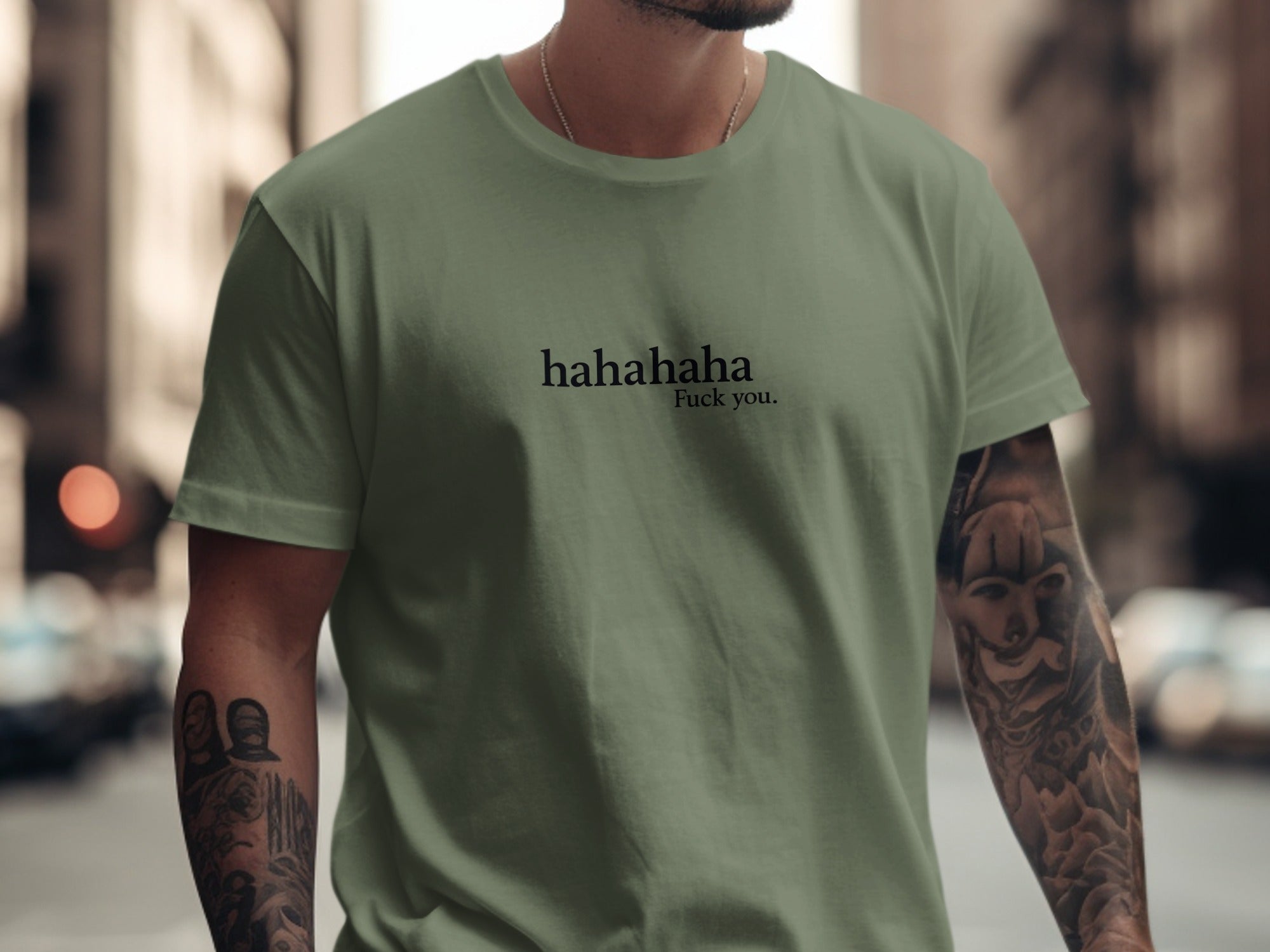 Olive green t-shirt with "hahahaha Fuck you." printed on the chest.