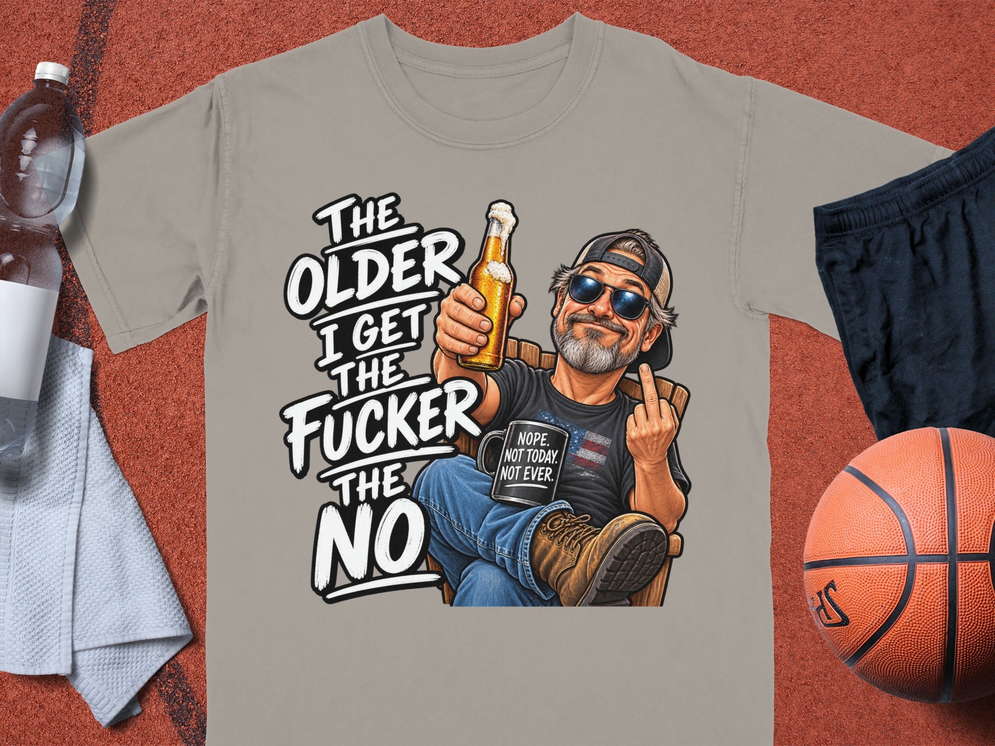 Gray t-shirt with illustration of man holding beer, showing middle finger. Text reads "The older I get the fucker the no."