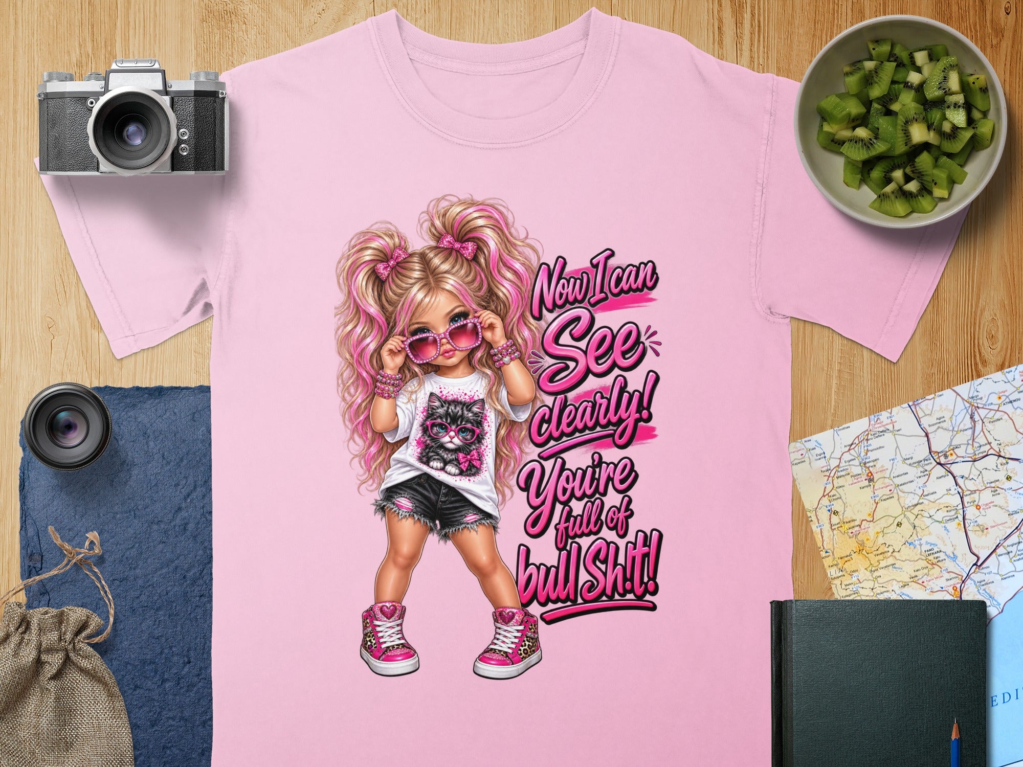 Pink t-shirt with a cartoon girl and cat graphic that reads "Now I can See Clearly! You're full of bull Shit!"