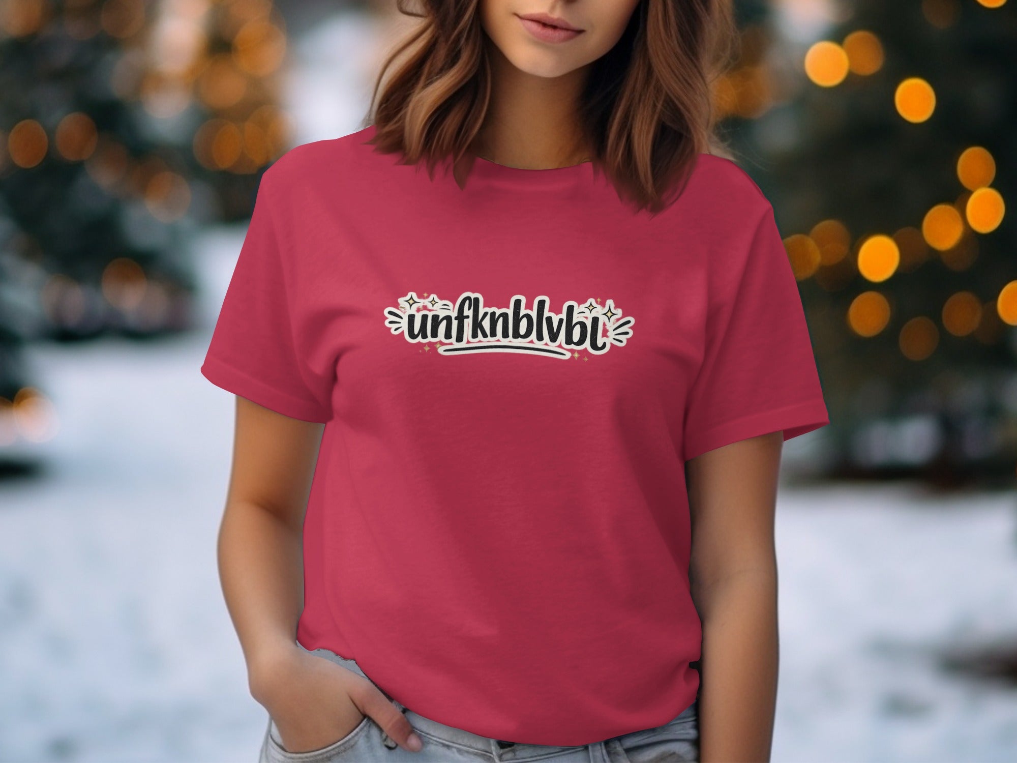 Red t-shirt with "unfknblvbl" graphic and holiday lights background