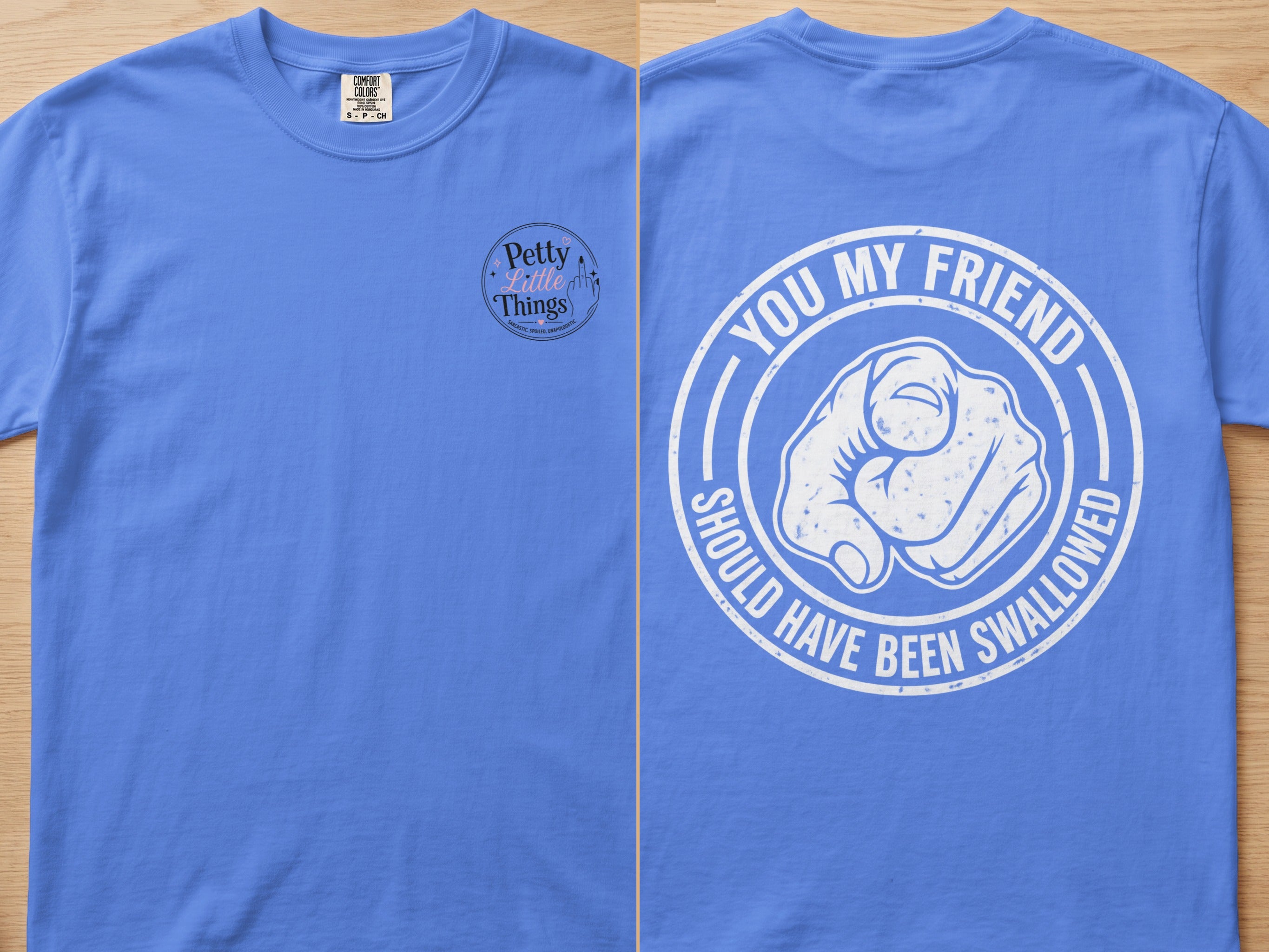 Blue t-shirt with "You my friend should have been swallowed" graphic.