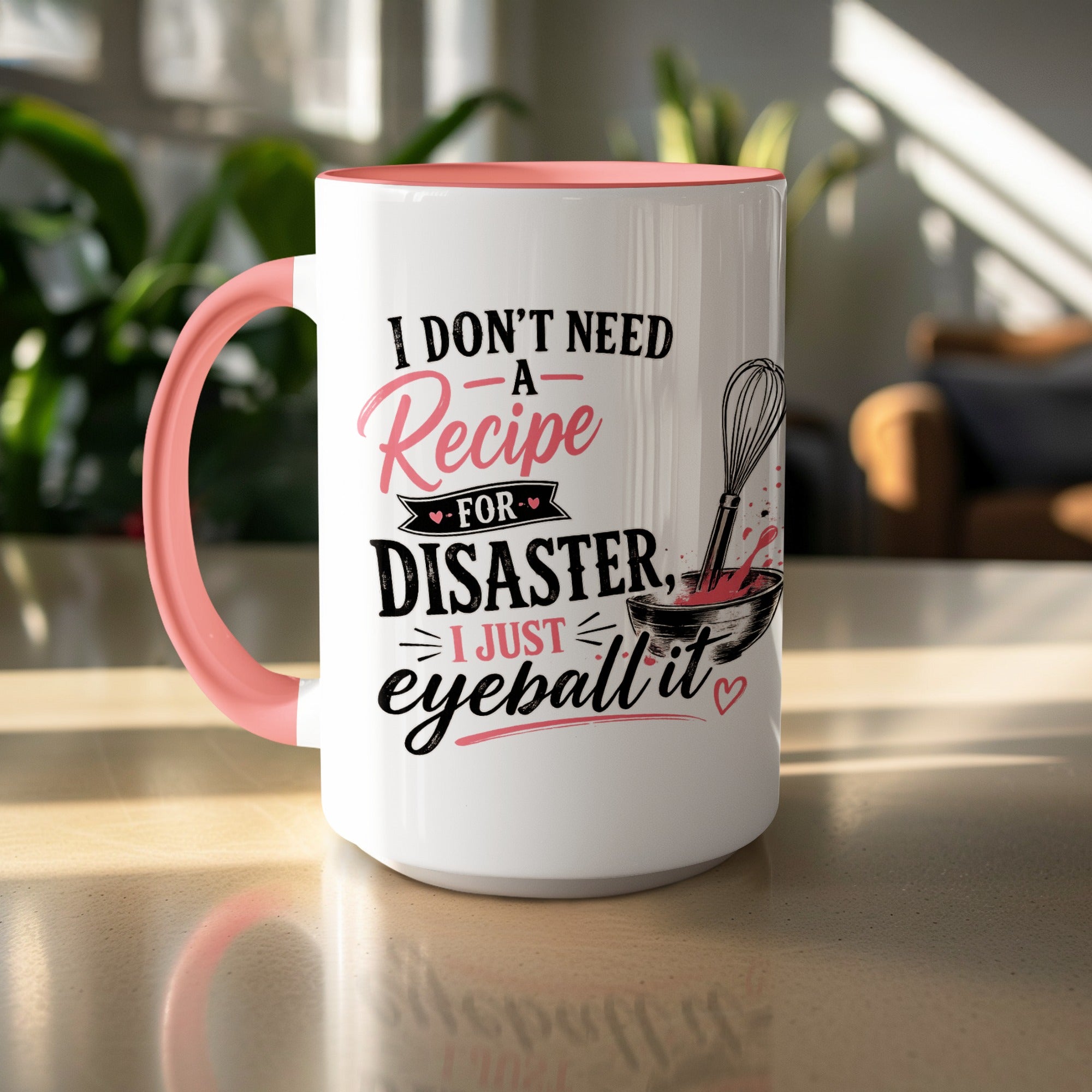 White mug with pink handle and rim featuring text and whisk graphic.