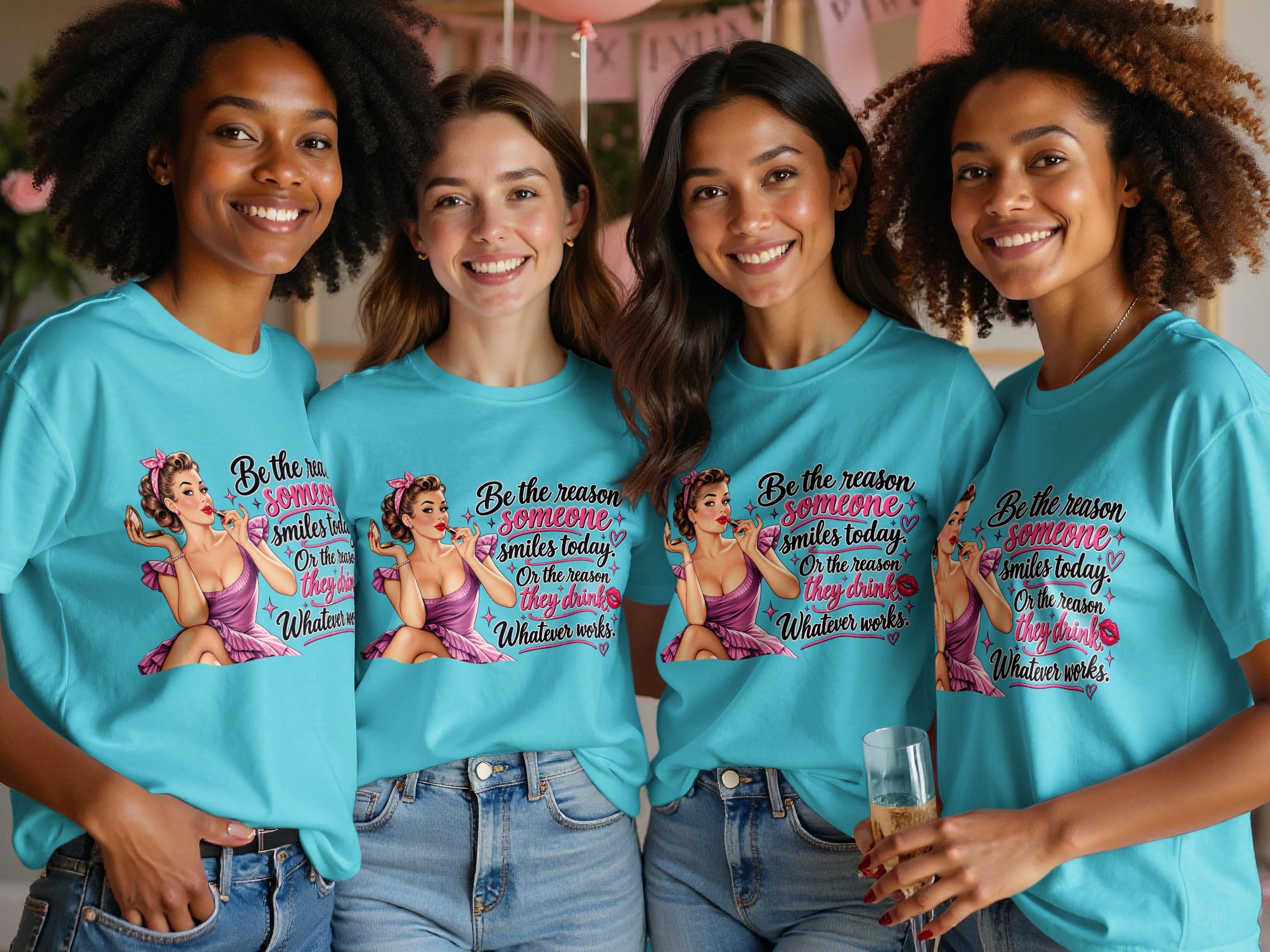 Four smiling women wear matching shirts with a pin-up graphic and text.