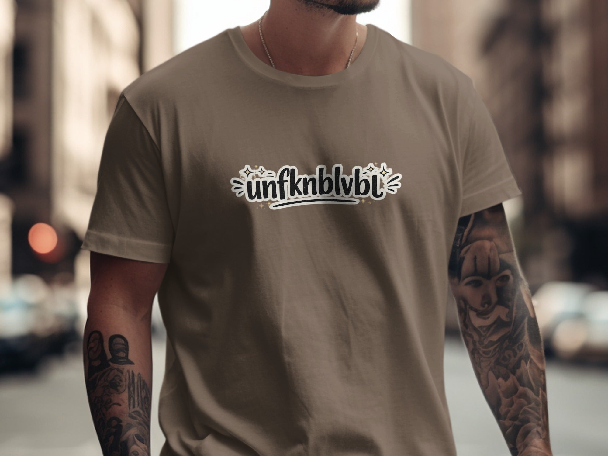 Brown t-shirt with "unfknblvbl" text graphic and stars.