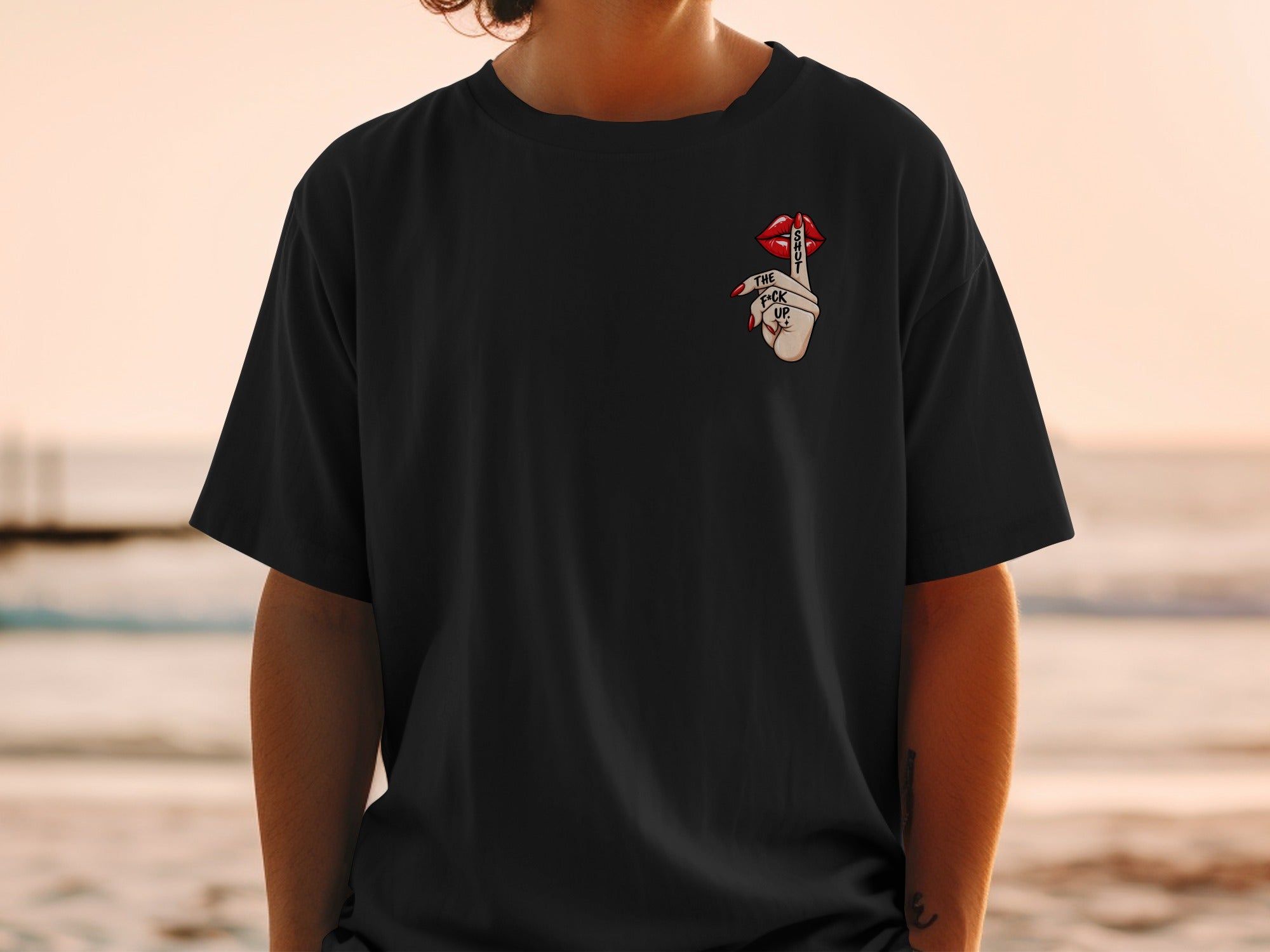 Black t-shirt with a graphic of lips and fingers saying "Shut the f*ck up".