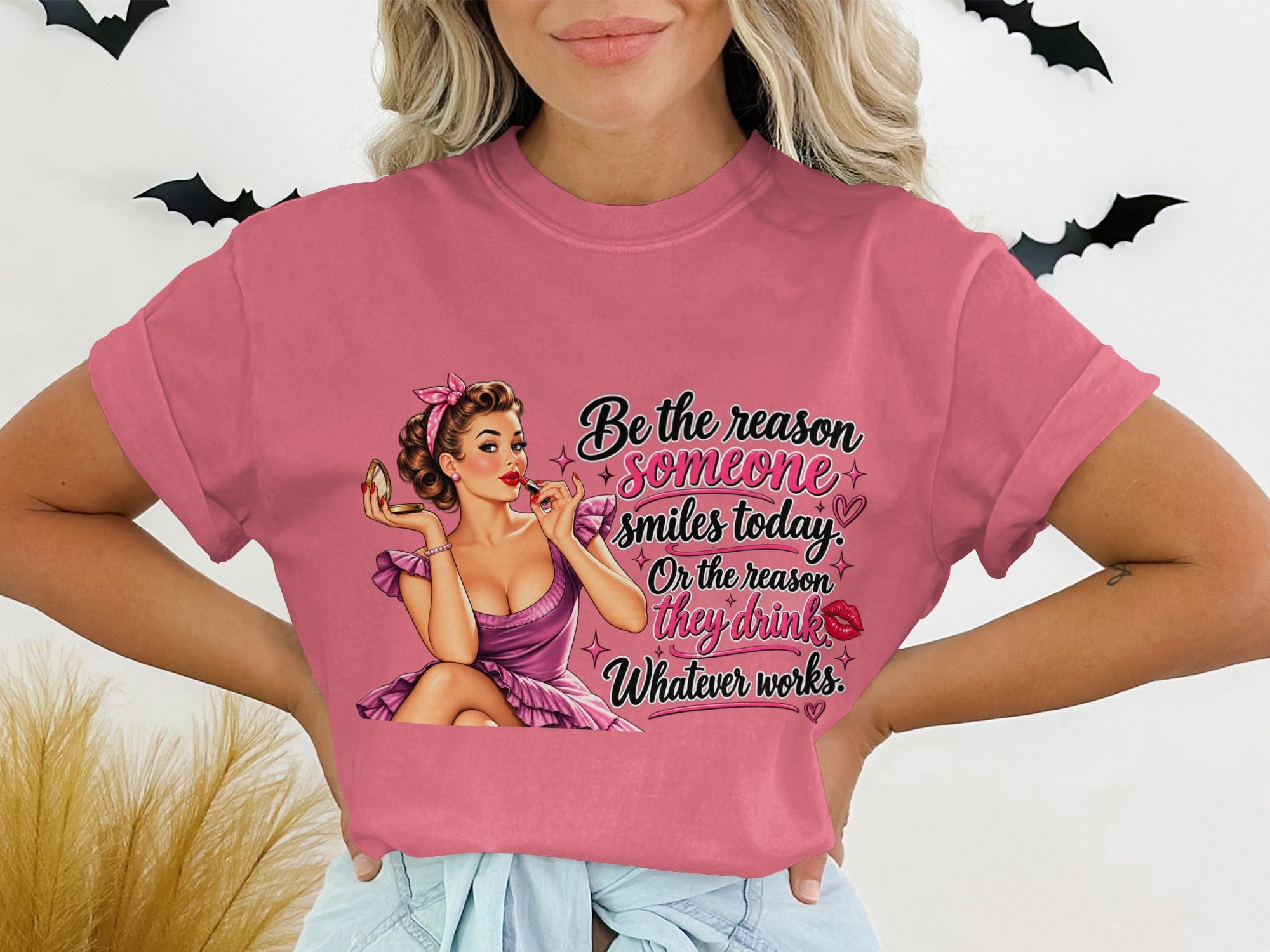 Pink t-shirt with "Be the reason someone smiles today. Or the reason they drink. Whatever works." text.